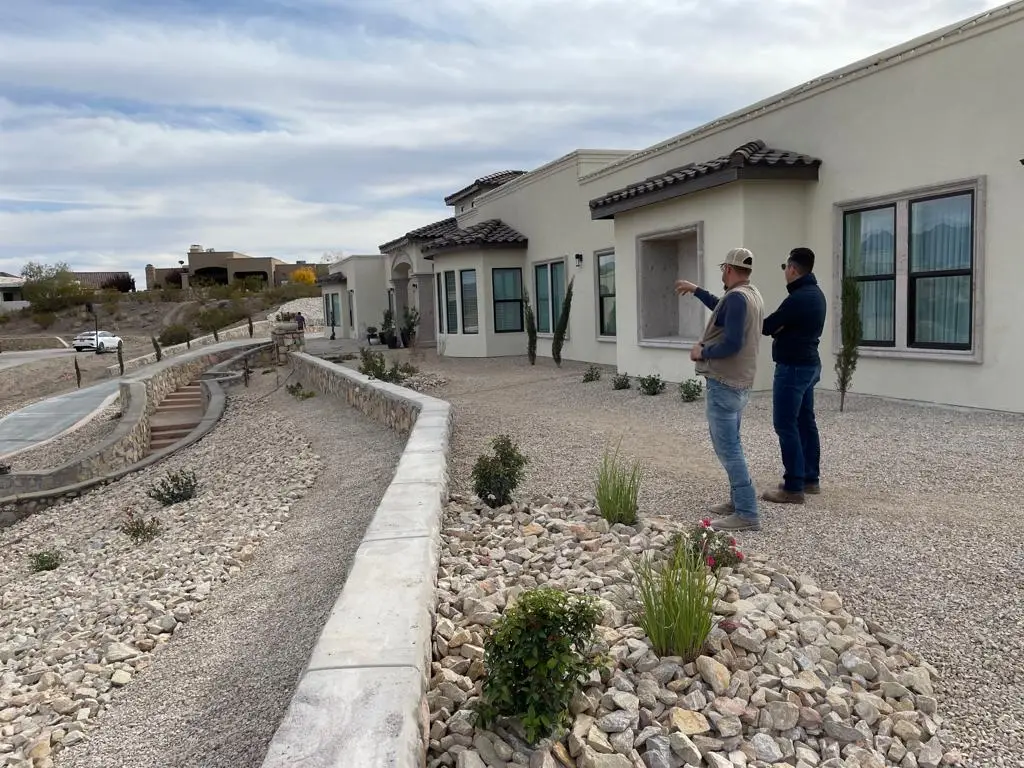 Owner of Black Rock Development is standing next to one of his workers. Both are overseeing the project.